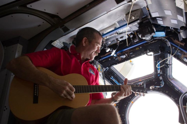 CAH playing Guitar in Space 3 - Photo Credit - NASA